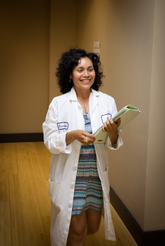 woman in lab coat smiling