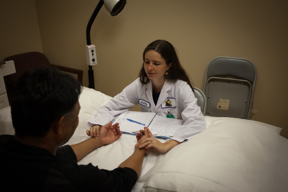 acupuncture student taking a patient's pulse