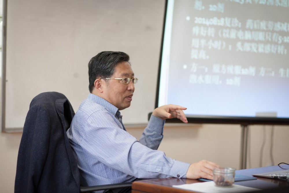 man speaking while sitting