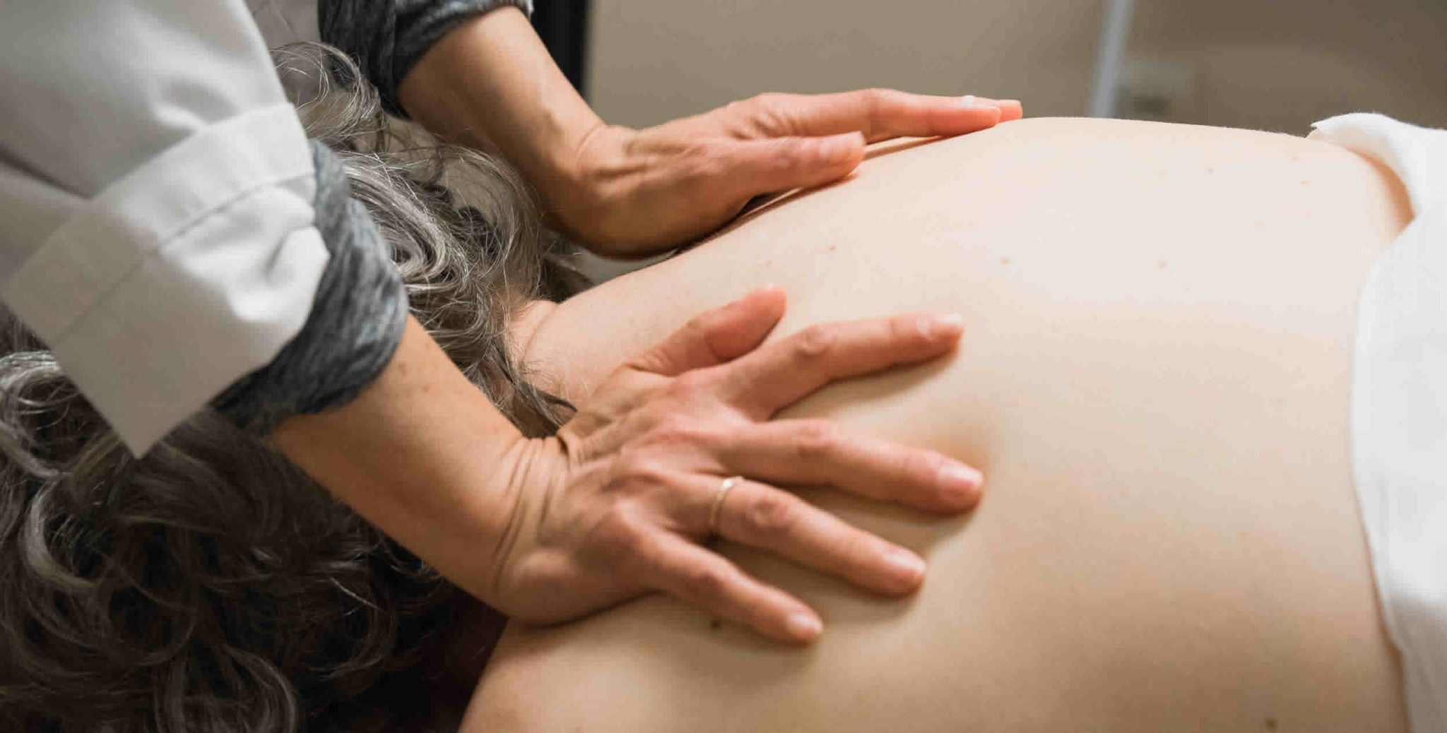 patient's back with practitioners hands doing tui na