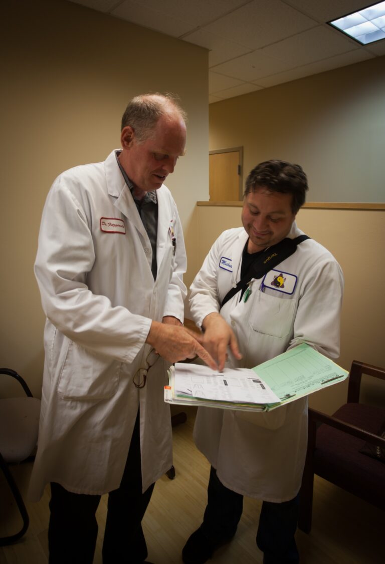 two men comparing acupuncture notes