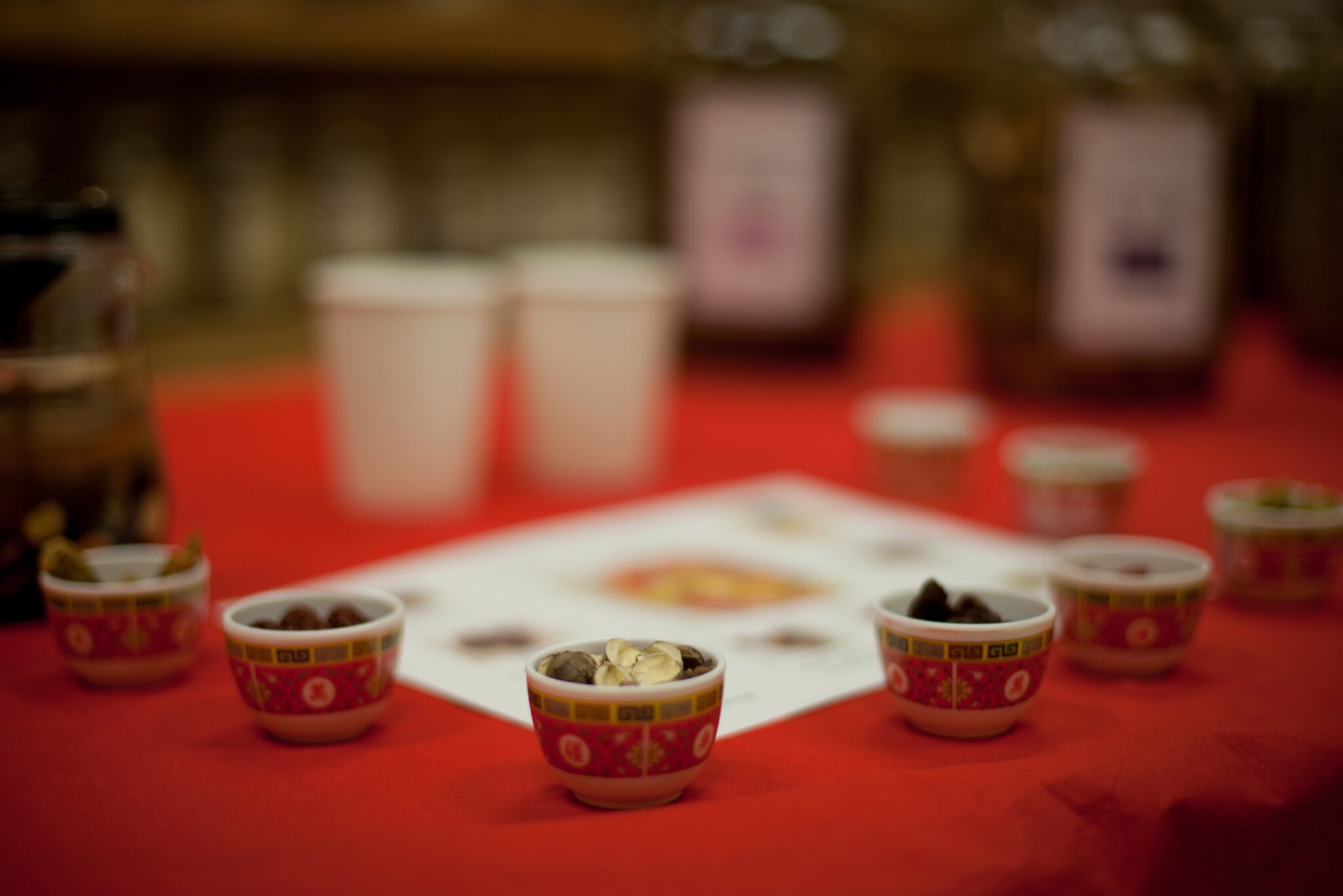 small cups of herbs sitting on a table