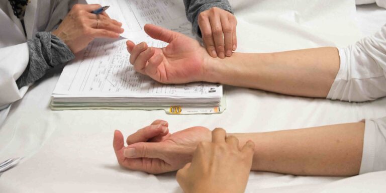 hands holding acupressure points