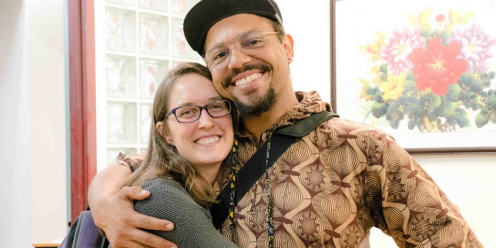 two acchs students smiling and hugging