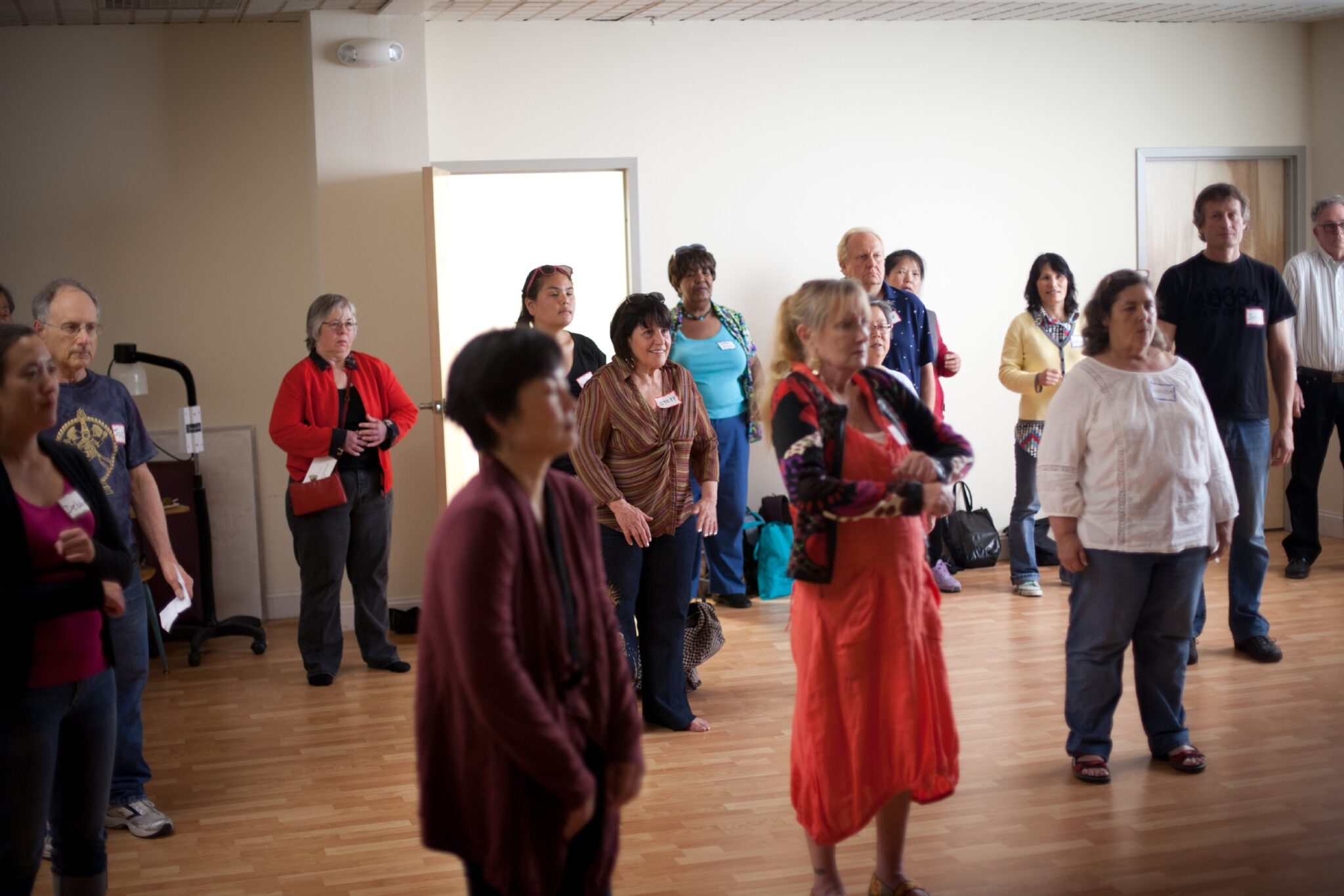 people standing in room listening to lesson