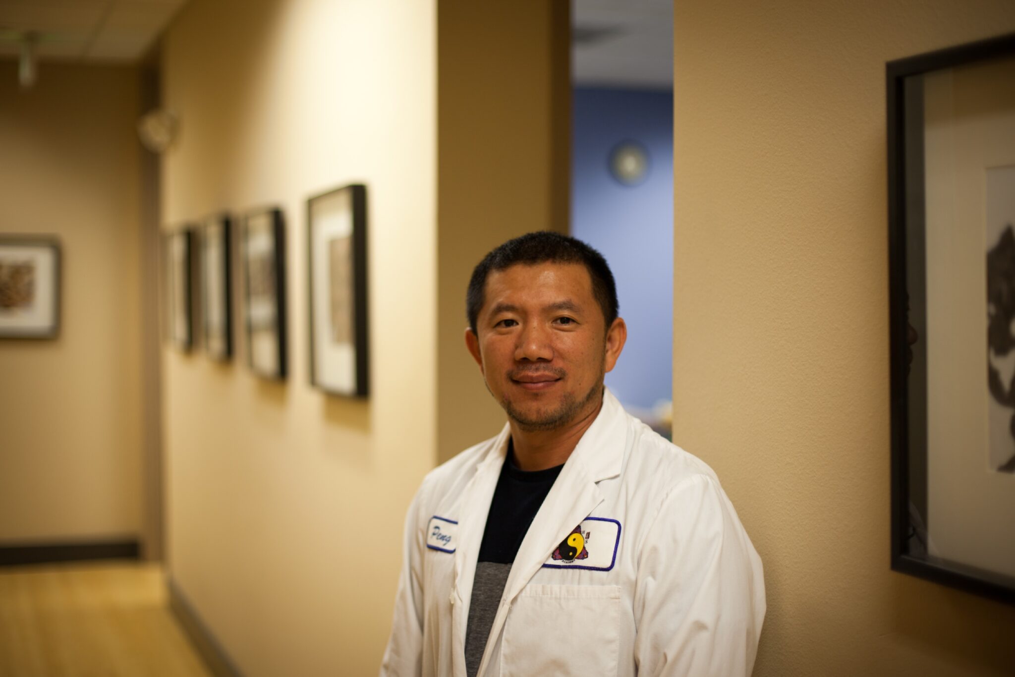 man in lab coat looking at camera