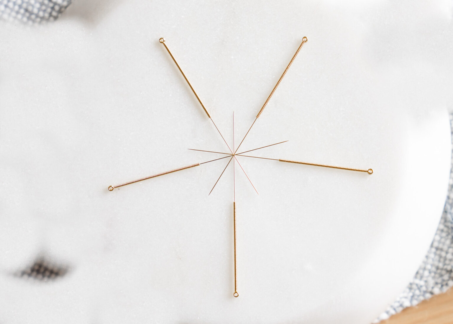 acupuncture needles place artfully in a circle